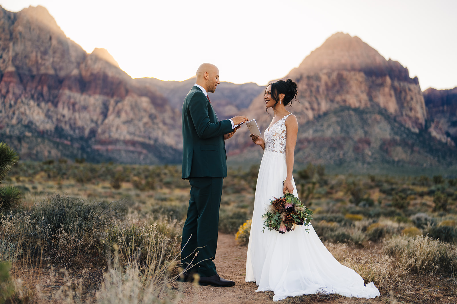 Couple exchanging vows during their elopement at Red Rock Canyon in Las Vegas captured by John Bognot Photography