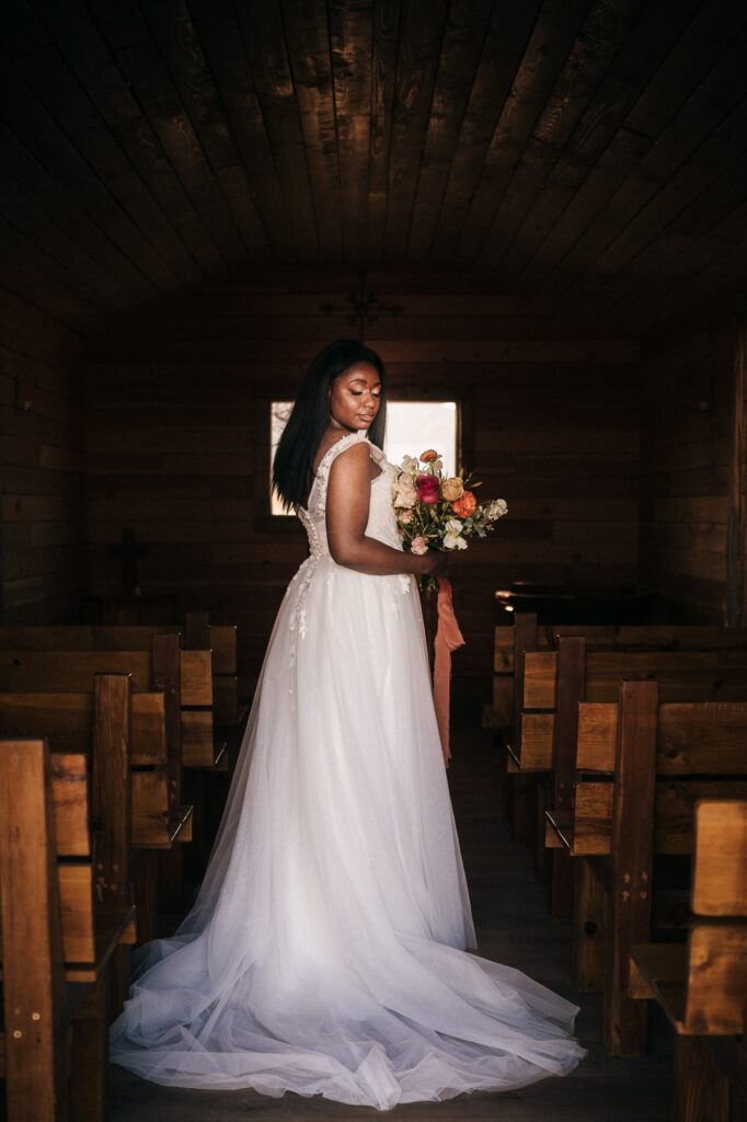 Bride Holding a bouquet of flowers inside the chapel at Cactus Joe's
