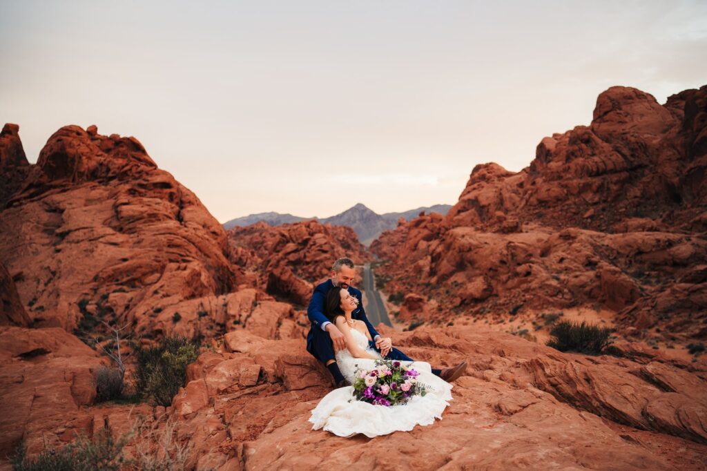 Couple sharing an intimate moment while sitting at one of the photo locations at Valley of Fire State Park during their wedding.