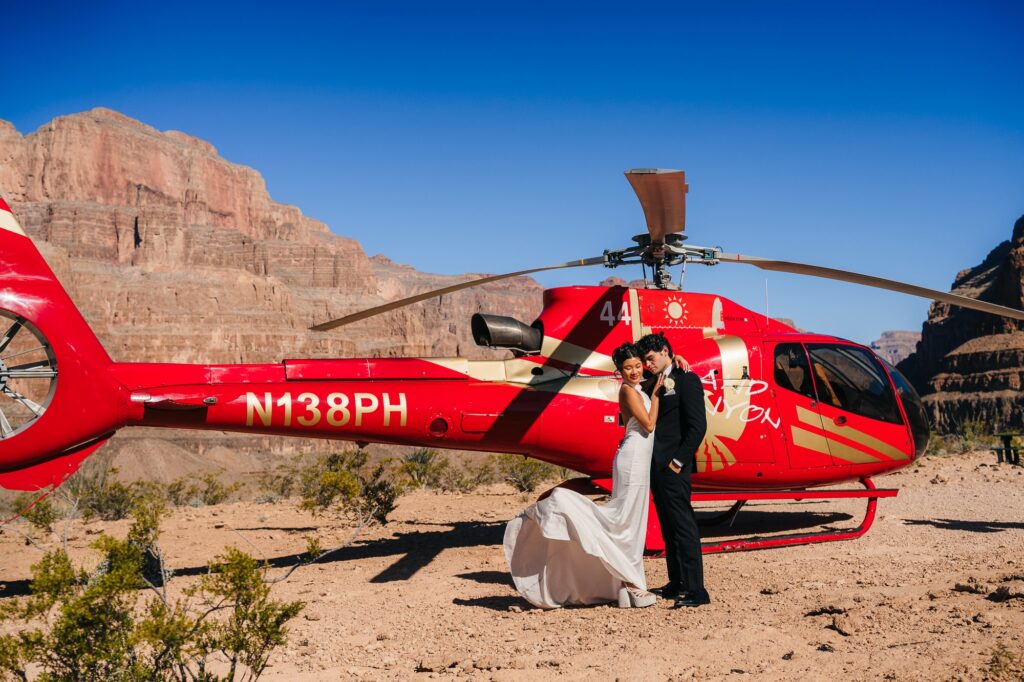 Couple's portrait at the Grand Canyon with a helicopter