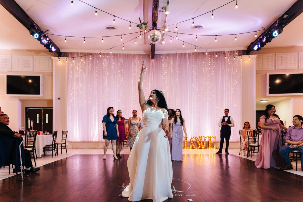 Bride tossing her bouquet during their wedding reception at The Grove in Las Vegas.