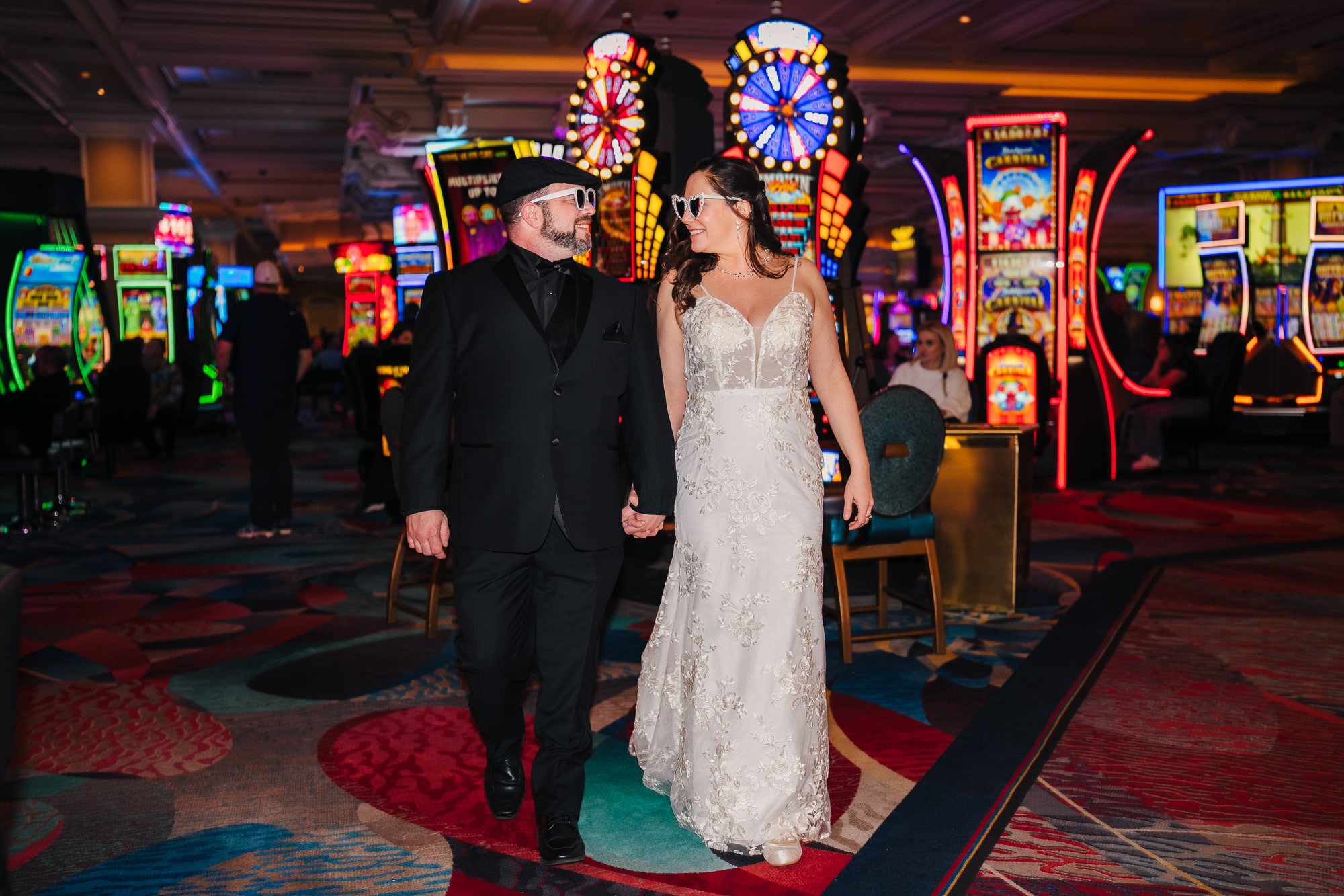 Couple walking in the casino after their elopement at the Little white wedding chapel in Las Vegas.