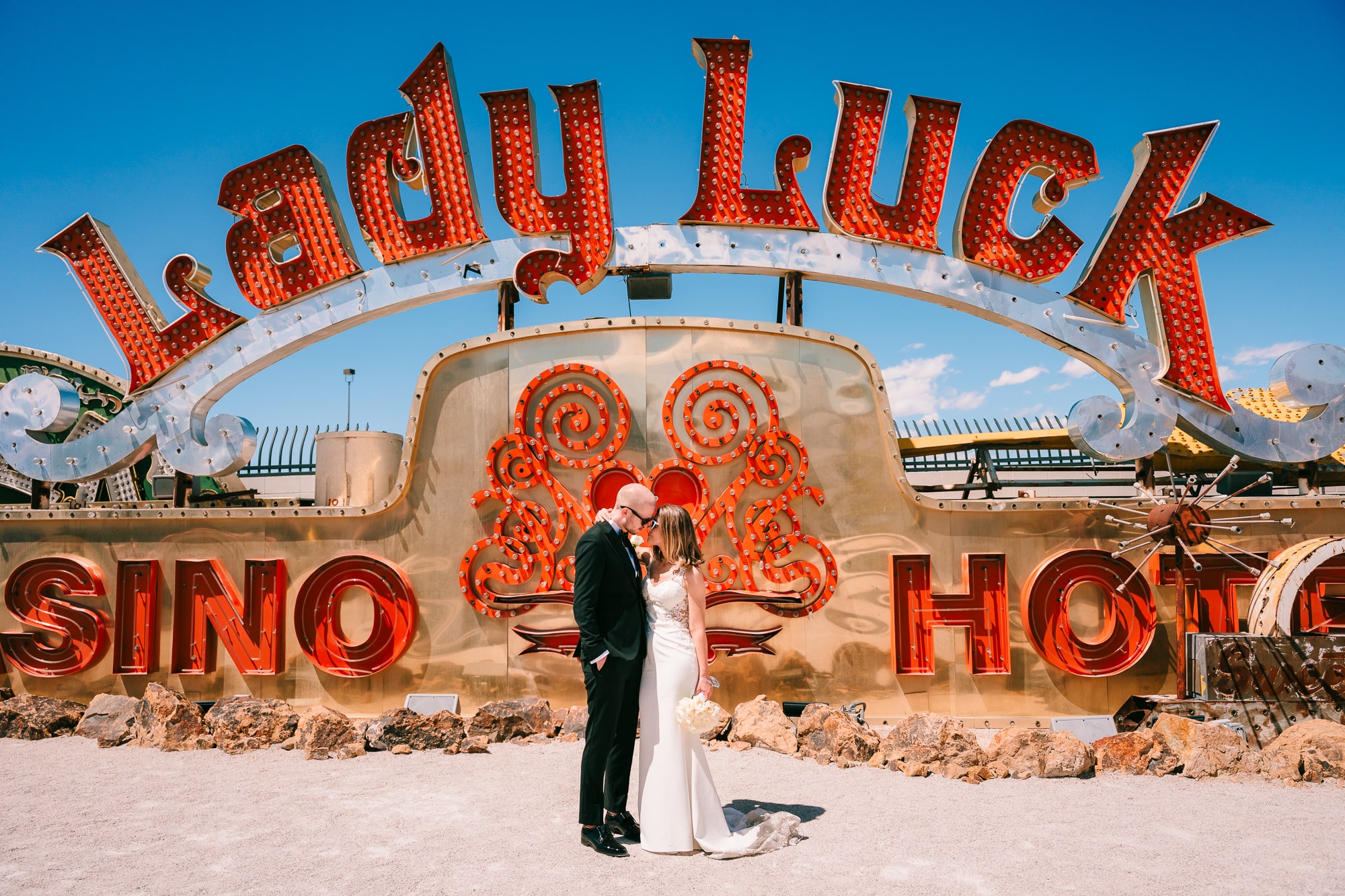 Newlywed sharing an intimate moment during their wedding at the Neon Museum in Las Vegas.