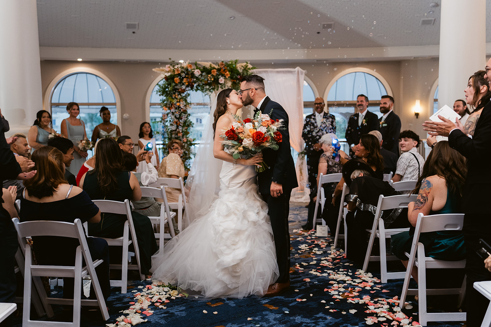 Newlywed sharing a kiss during their wedding at JW Marriott LV
